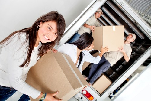 Professional movers packing household items for a Havering relocation