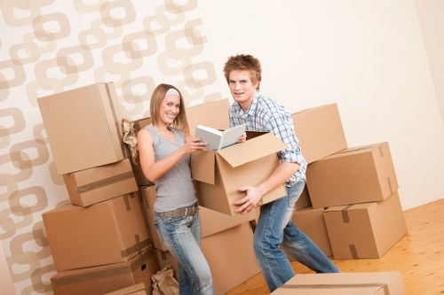 Removal team carrying furniture during a house move in Havering